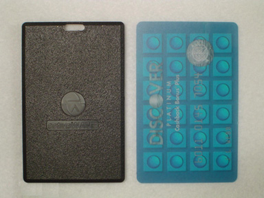 The cardTag: a black tag the size of a credit card, with a slot at the top, beside a credit card.
