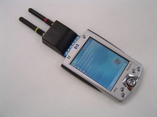 The CF Reader plugged into the top of a handheld computer, with two short antennas above the screen.