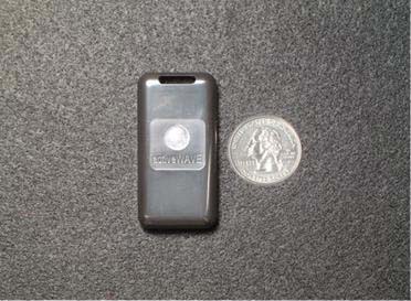 The compactTag: a dark gray tag the size of a car remote, with a slot at one end, beside a US quarter.
