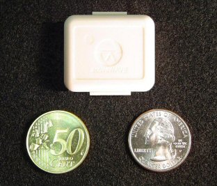 The miniTag: a small, square white tag above a 50 euro cent coin and a US quarter.